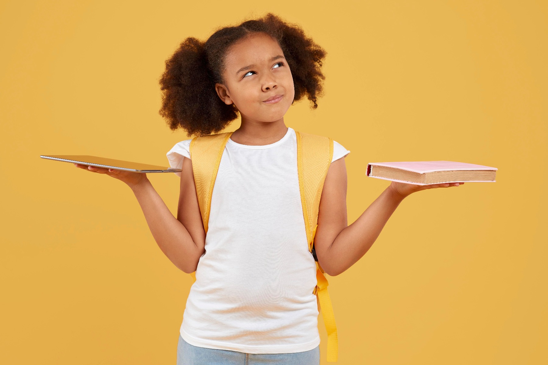 small-school-girl-choosing-tablet-book